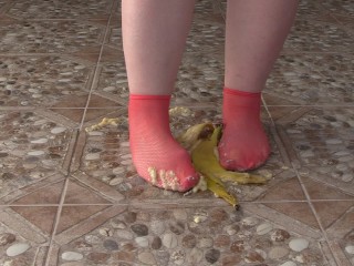 Fat legs in socks ruthlessly trample banana. Crush Fetish, foot fetish.